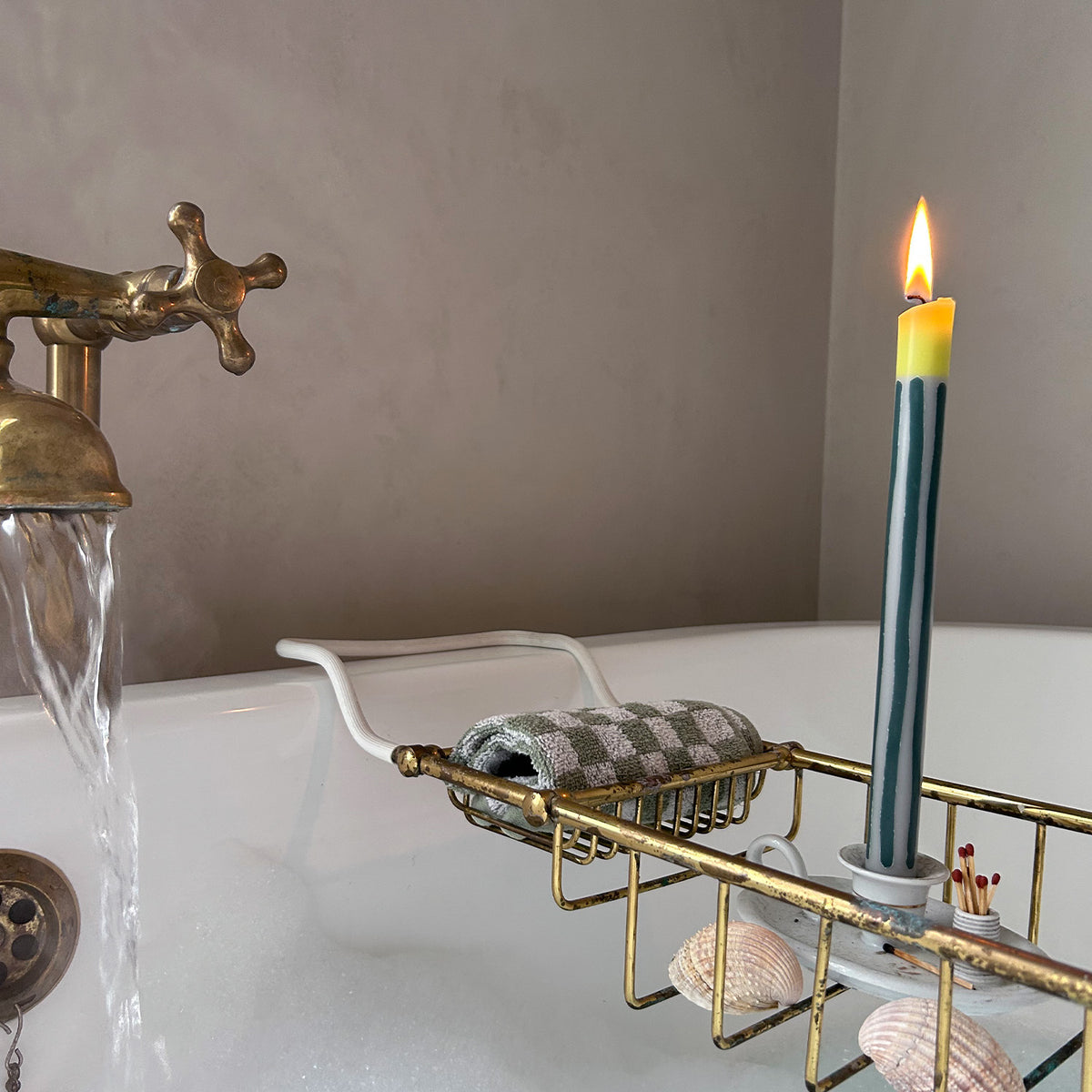 Bergamot striped dinner candles by Pygmalion London, a hand-poured pair in racing green, off-white and pistachio yellow