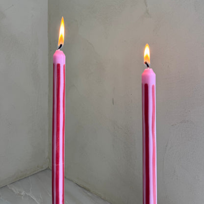 Rhubarb striped dinner candles by Pygmalion London, a hand-poured pair in red and parlour pink