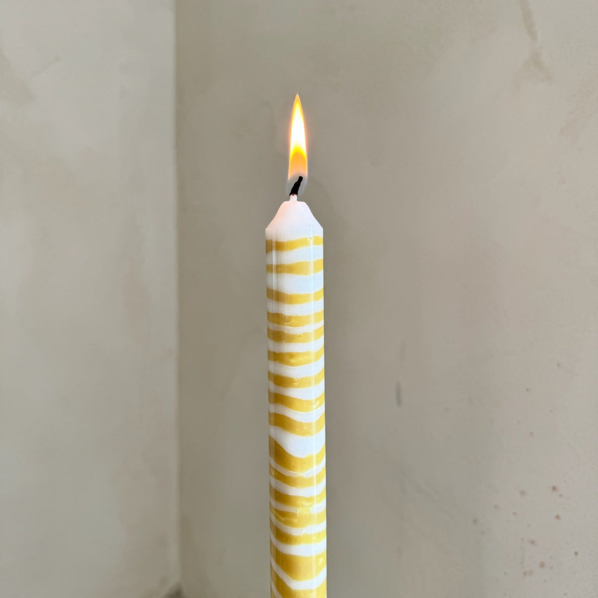 Piccalilli sculptural dinner candles by Pygmalion London, a hand-poured pair in mustard yellow and off-white