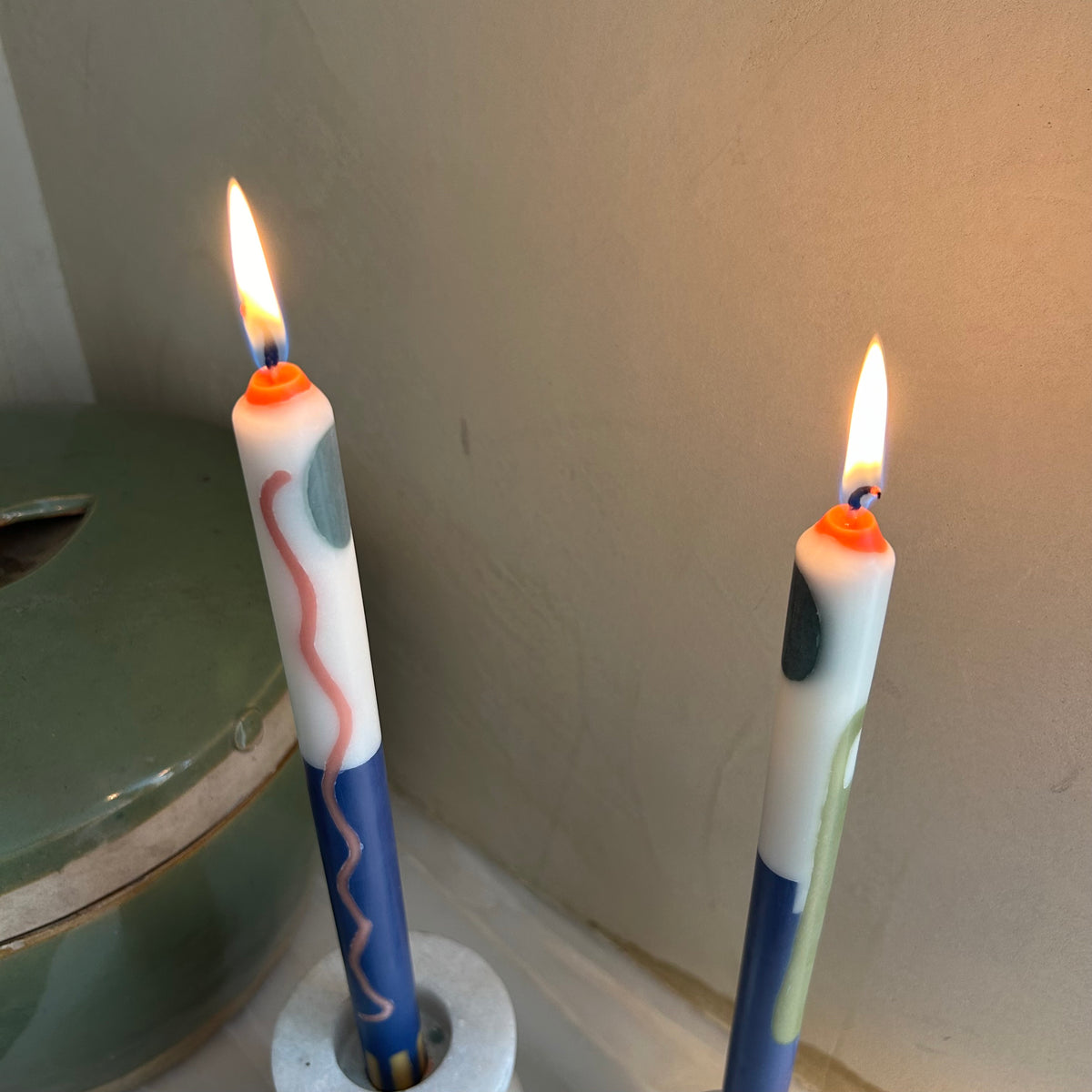 Terracotta patterned dinner candles by Pygmalion London, a hand-poured pair in blue, burnt orange, ochre, mustard yellow, racing green and red