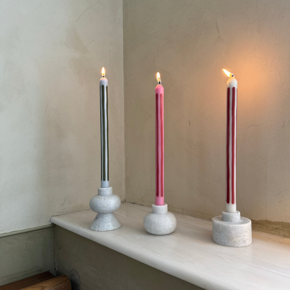 Rhubarb striped dinner candles by Pygmalion London, a hand-poured pair in red and parlour pink
