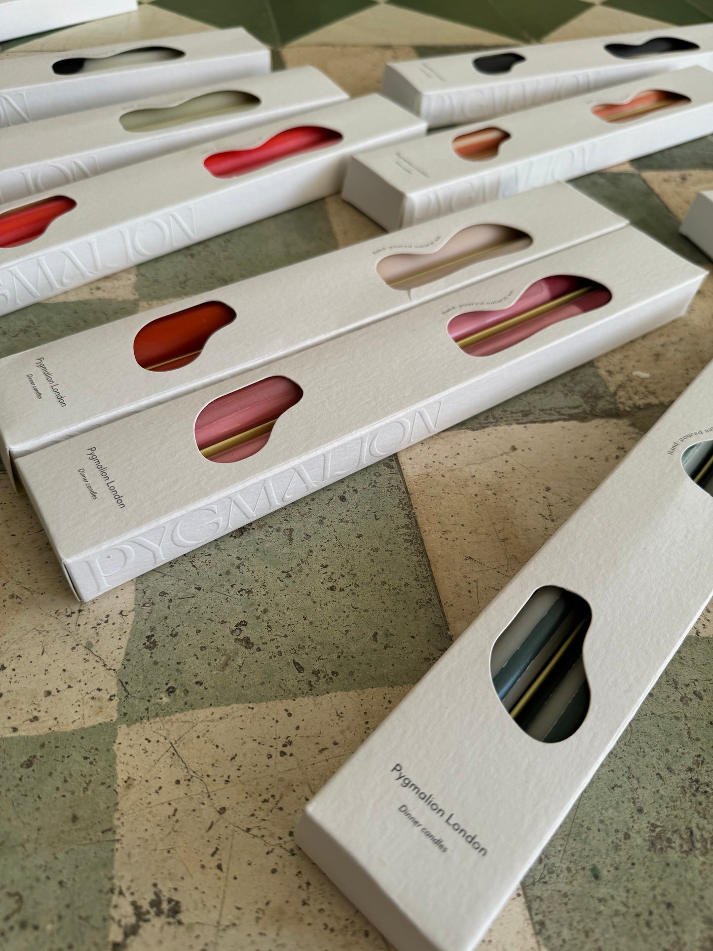 Rhubarb striped dinner candles by Pygmalion London, a hand-poured pair in red and parlour pink
