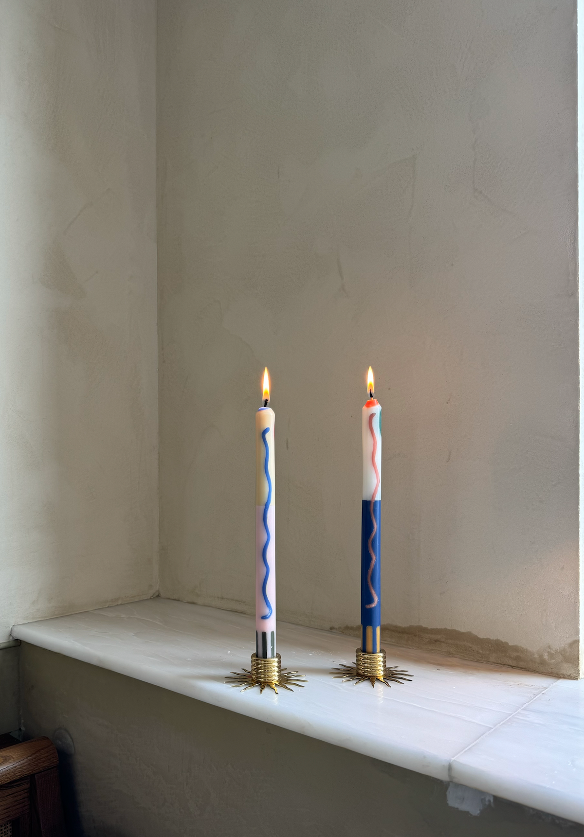 Terracotta patterned dinner candles by Pygmalion London, a hand-poured pair in blue, burnt orange, ochre, mustard yellow, racing green and red