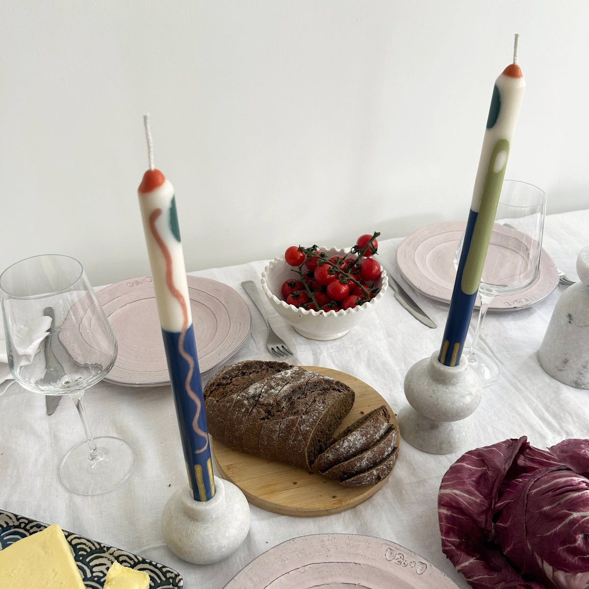Terracotta patterned dinner candles by Pygmalion London, a hand-poured pair in blue, burnt orange, ochre, mustard yellow, racing green and red