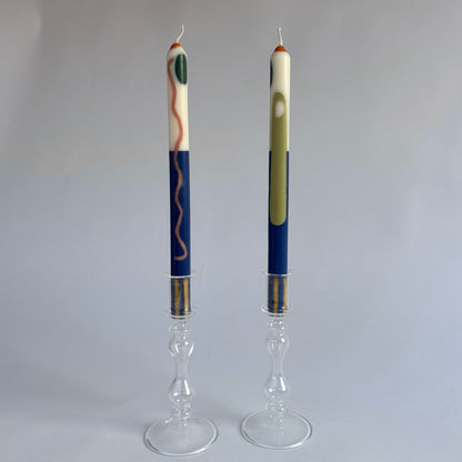 Terracotta patterned dinner candles by Pygmalion London, a hand-poured pair in blue, burnt orange, ochre, mustard yellow, racing green and red