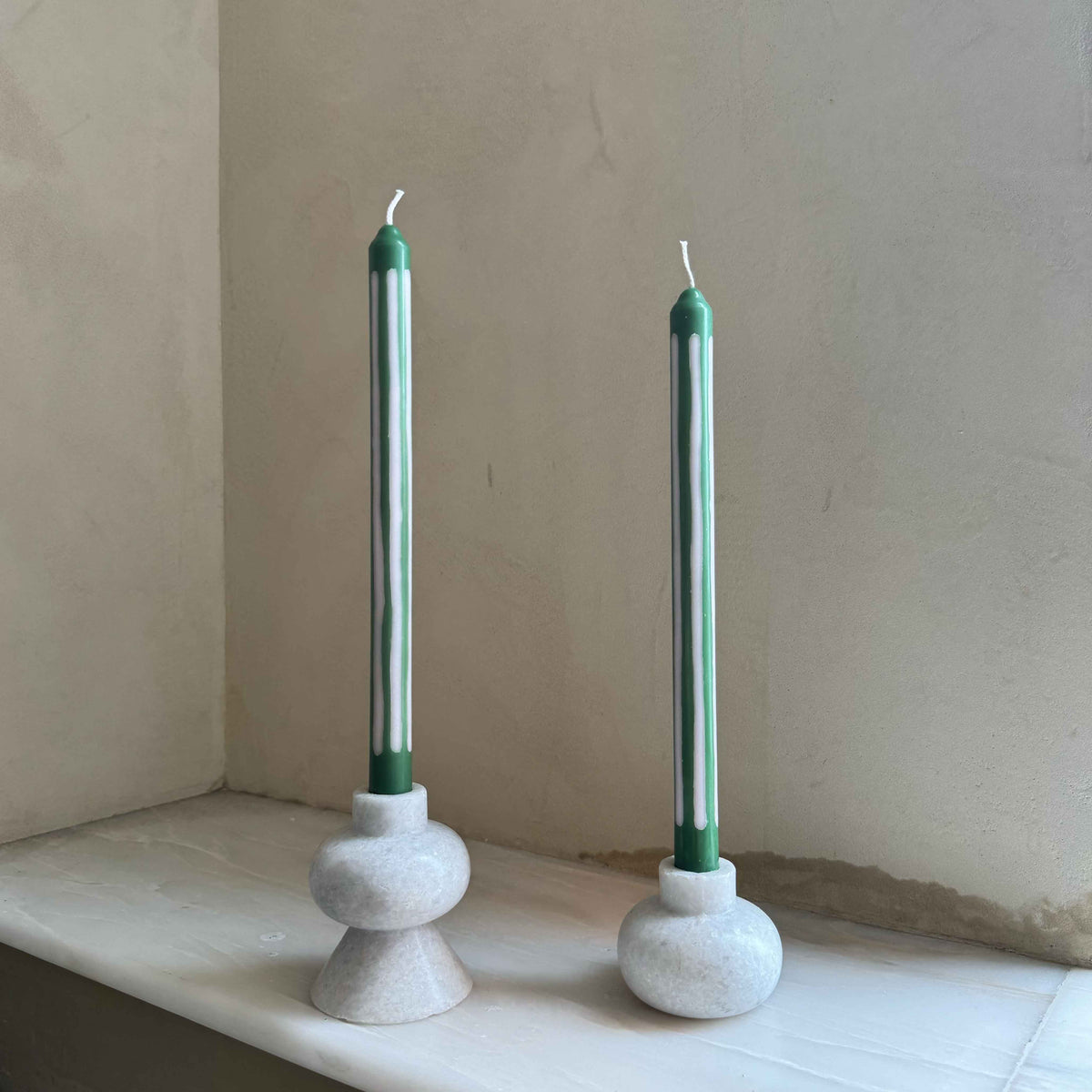 Wimbledon striped dinner candles by Pygmalion London, a hand-poured pair in palest oyster pink and emerald green