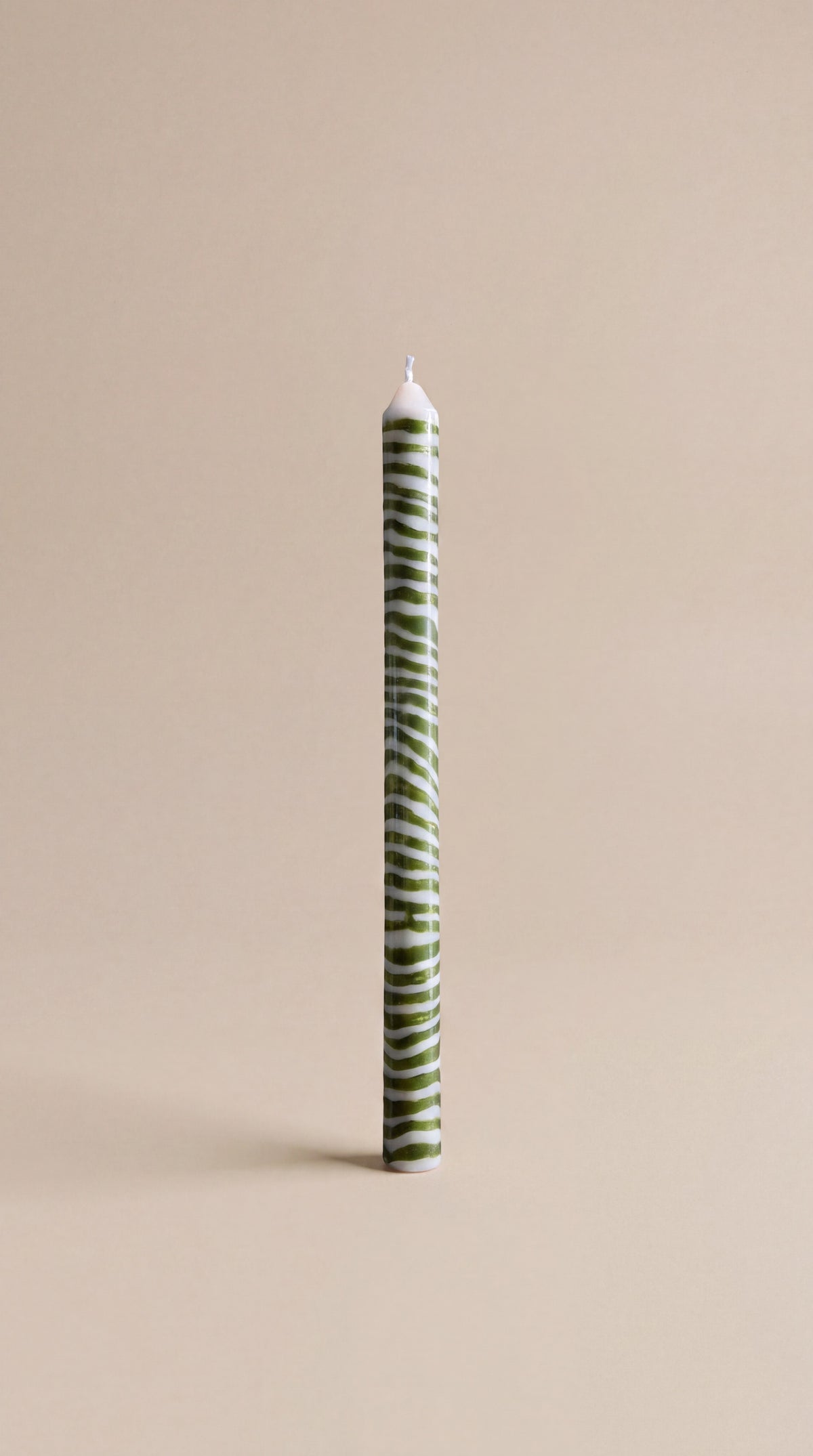 A green and white striped Pygmalion dinner candle, the colour running right through the wax